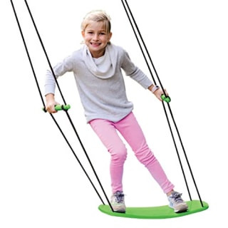 Swurfer Stand-Up Surfing Tree Swing with a child standing on it in a backyard