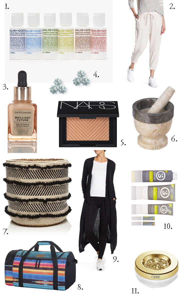 A curated selection of healthy and thoughtful gifts for moms under $50, arranged on a white surface with natural light, highlighting skincare, loungewear, and wellness items