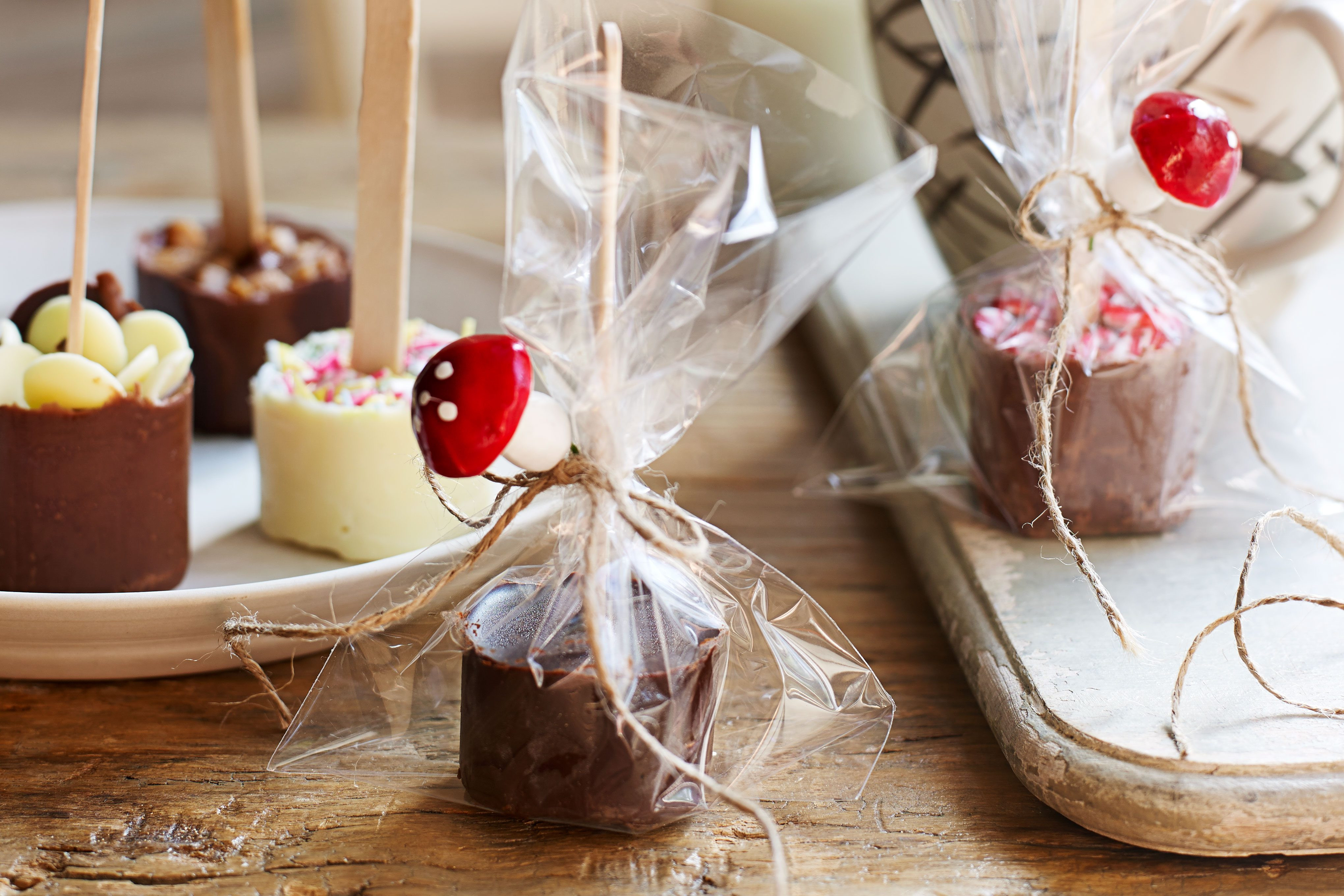 Hot chocolate stirrers, some gift wrapped and some on a plate