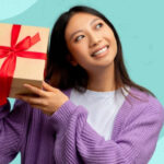 Nurse holding gift and smiling genuinely, representing thoughtful appreciation for nurses