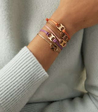 Tory Burch Embrace Ambition Bracelet in gold, an inspirational coworker gift with a subtle message.