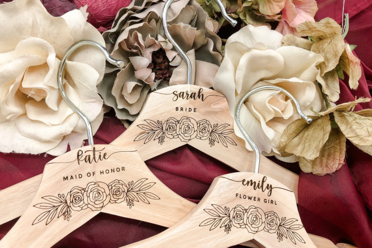 Personalized wooden hangers with names, a practical and affordable bridesmaid gift.