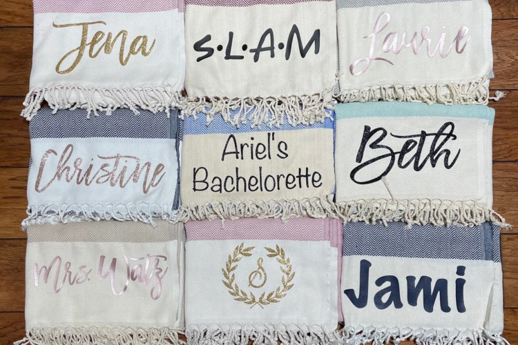 Beach bags filled with towels and beach essentials, a fun and summery bridesmaid gift bag idea.