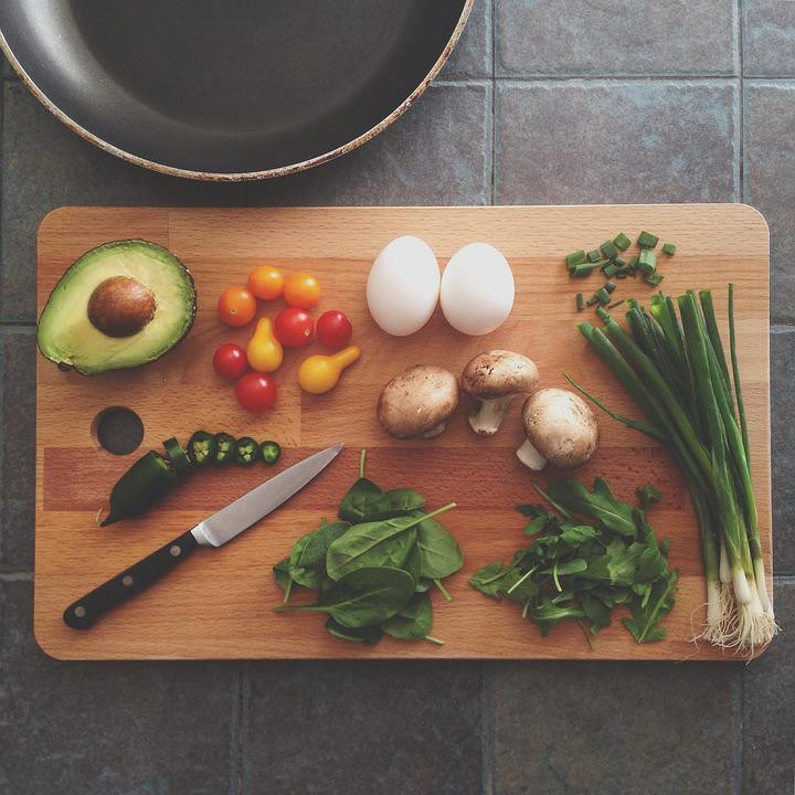 A cutting board flat-lay photo with vegetables and a kitchen knife