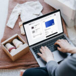 woman typing in payment information at checkout screen of online baby store