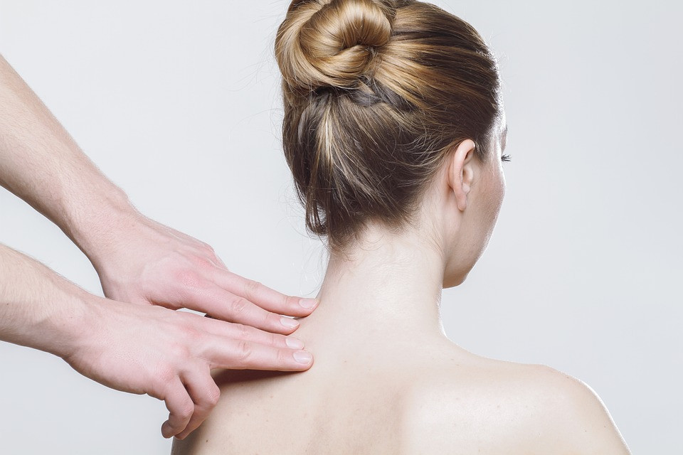 Hands massaging a woman