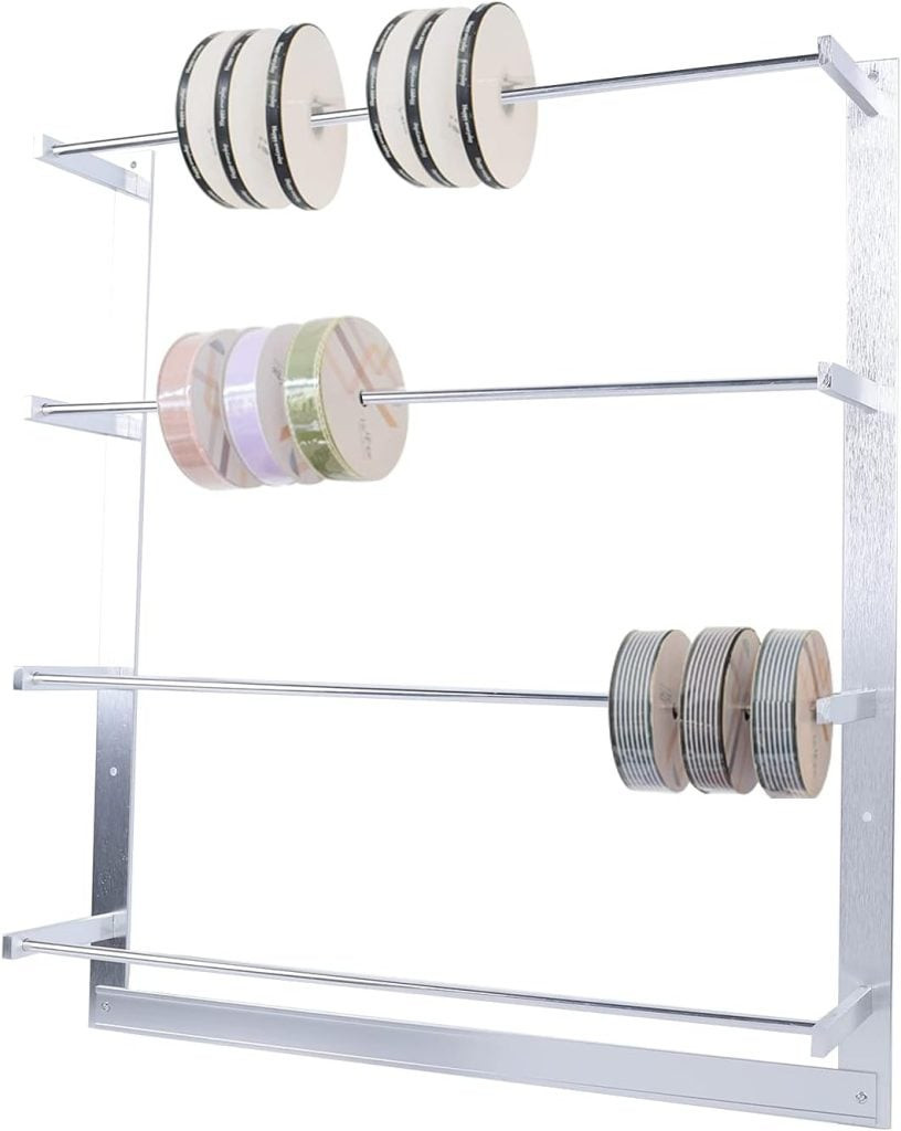 A metal rack with three horizontal rods elegantly holds multiple spools of ribbon, showcasing a delightful array of colors and patterns perfect for gift wrapping, presenting an attractive ribbon organization solution.