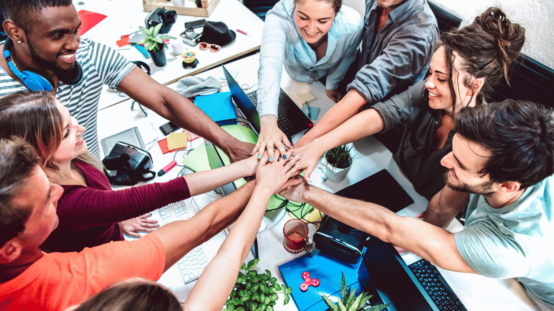 Team members celebrating success with a group hug