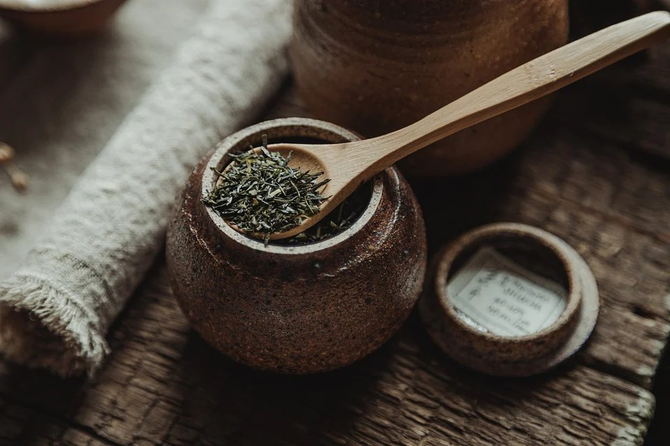 A wooden spoon with spices in it