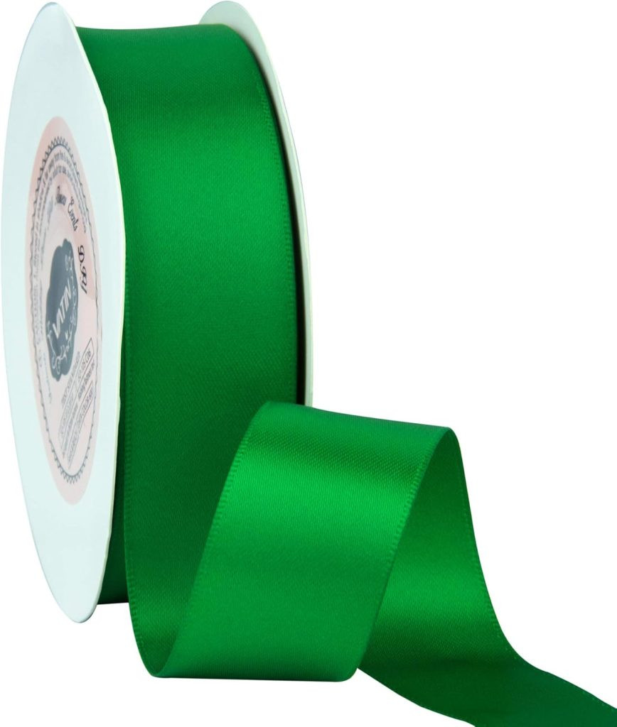 A roll of green satin ribbon, perfect for gift wrapping, partially unspooled with a white circular holder, presenting a festive and classic ribbon color.
