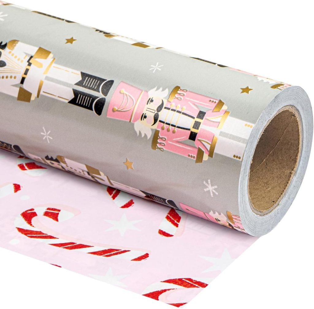 A roll of gift wrapping paper showcasing nutcracker designs on the outer layer and candy cane patterns on the inner layer, demonstrating festive reversible gift packaging.