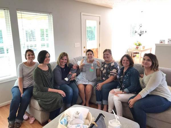 Assortment of baby shower gifts including clothes, toys and essentials