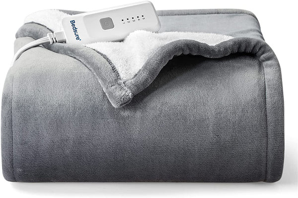 A folded Soft Heated Blanket Throw on a couch, a comforting and warm birthday gift idea for a wife.