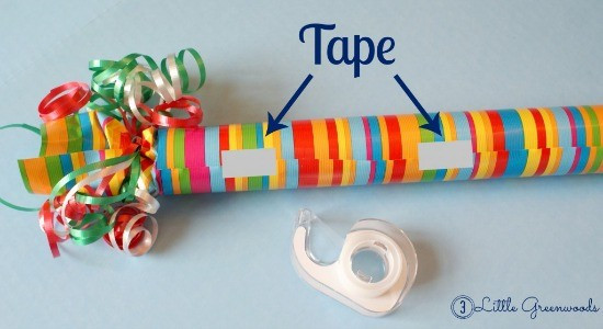 Wrapping a paper towel roll with colorful paper for a homemade birthday gift.