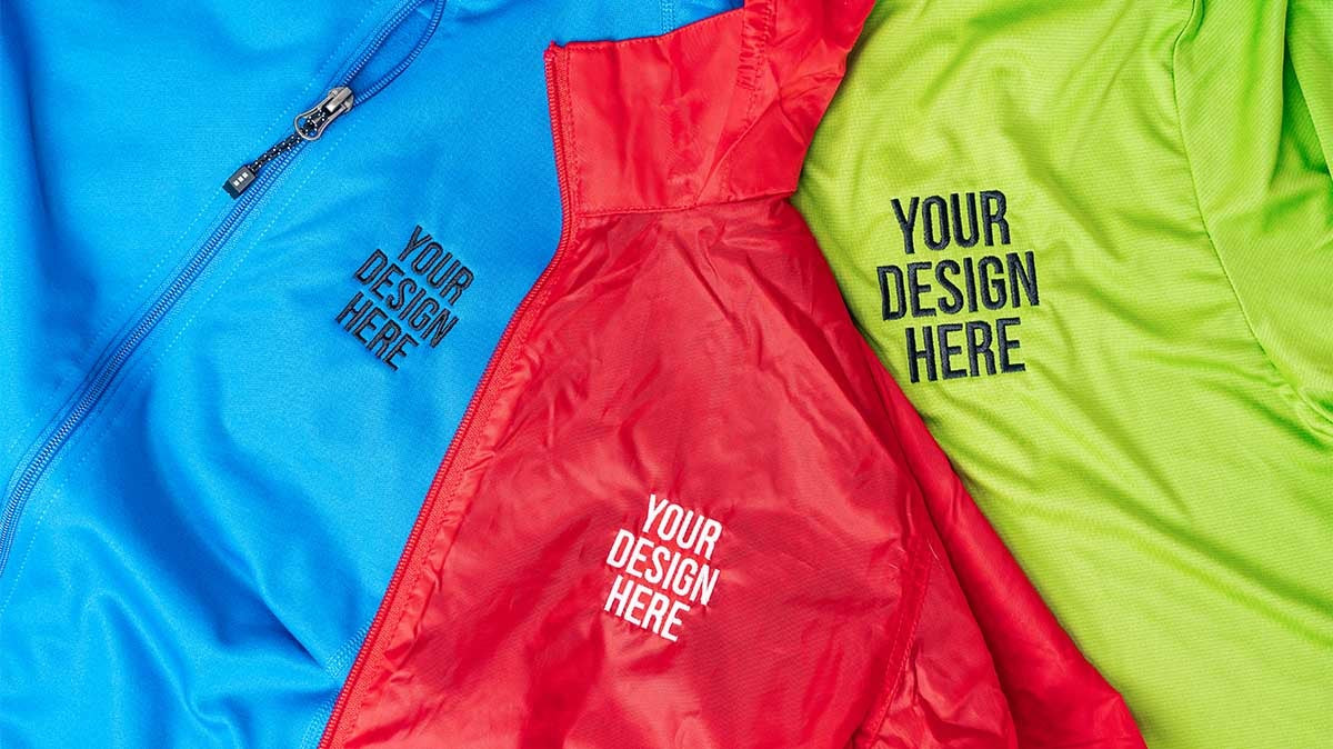 Close-up of embroidered logo on fabric, showcasing detail and quality, relevant to promotional apparel.