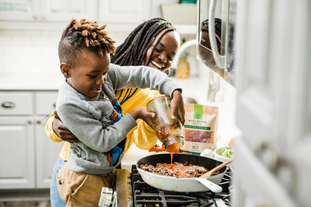 A child engrossed in a cooking class, showcasing the engaging and educational experience that can be a thoughtful gift.