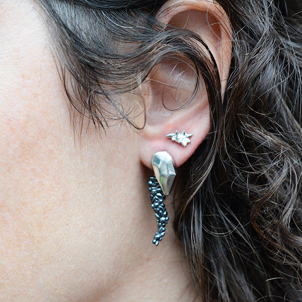 polished and darkened sterling silver rock cascade earring with tiny succulent silver earring in second hole