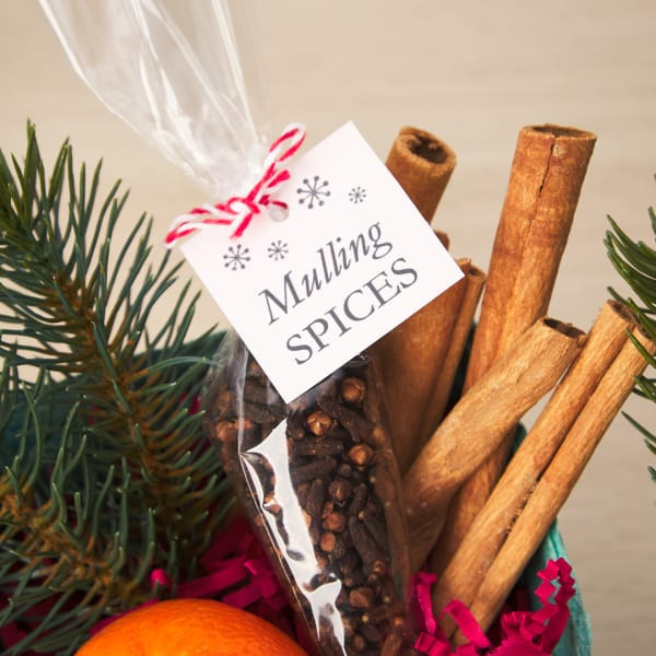 Gift tag for mulling spices Christmas gift is printed on square Avery tag 22849. There are simple snowflakes and it reads, 