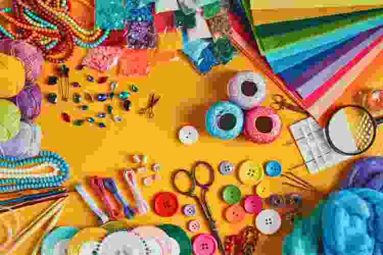 Various craft supplies and materials are neatly arranged on a bright table, showcasing items from Annie's Kit Clubs.