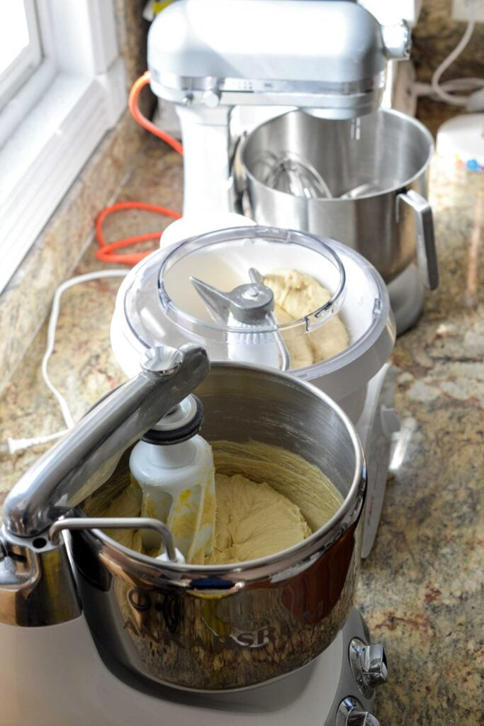 A stand mixer kneading sourdough dough in its bowl, demonstrating the appliance's power and efficiency in dough preparation.