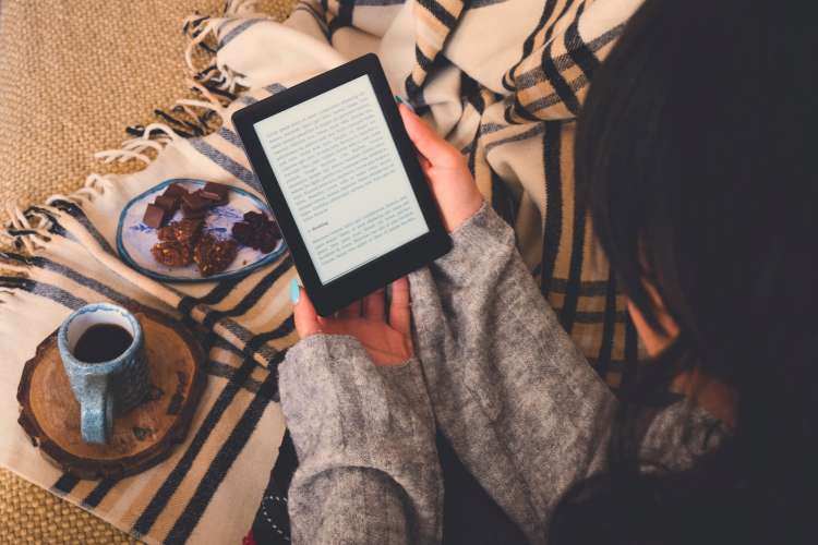 E-reader, a thoughtful tech birthday gift idea for wife who loves to read, providing portable access to a vast library (via Canva)