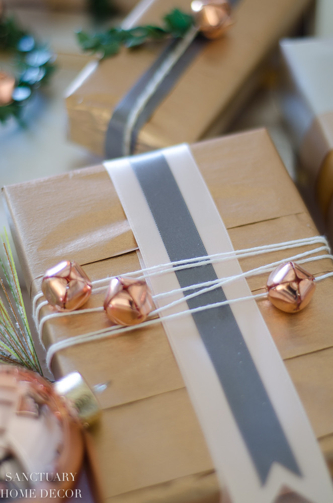 Close up detail shot of blush wrapped christmas gift with copper tissue paper and ribbon