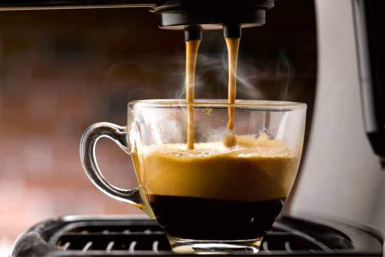 A sleek espresso machine in a kitchen setting, emphasizing the gift of a home coffee experience for married couples.