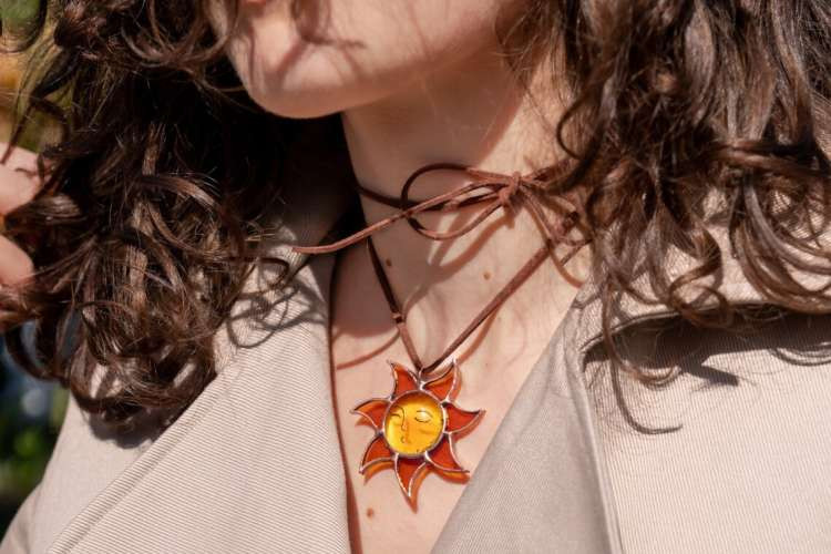 A collection of unique glass jewelry pieces, including necklaces and earrings, showcasing their artistic and eco-friendly appeal