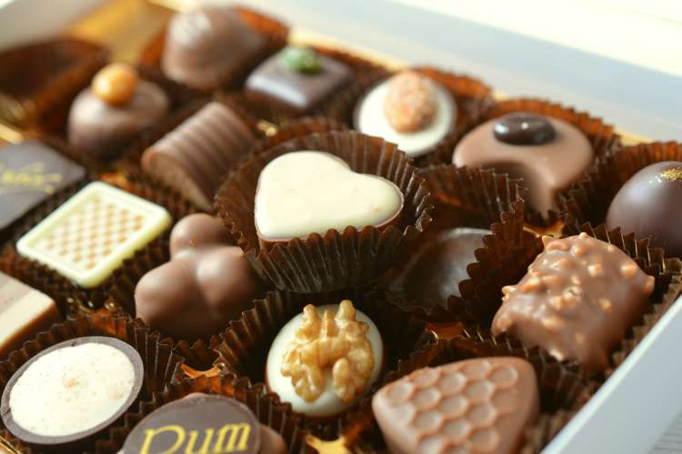 Gourmet chocolate box, an indulgent luxury birthday gift idea for wife, offering exquisite treats for her special day (via Canva)