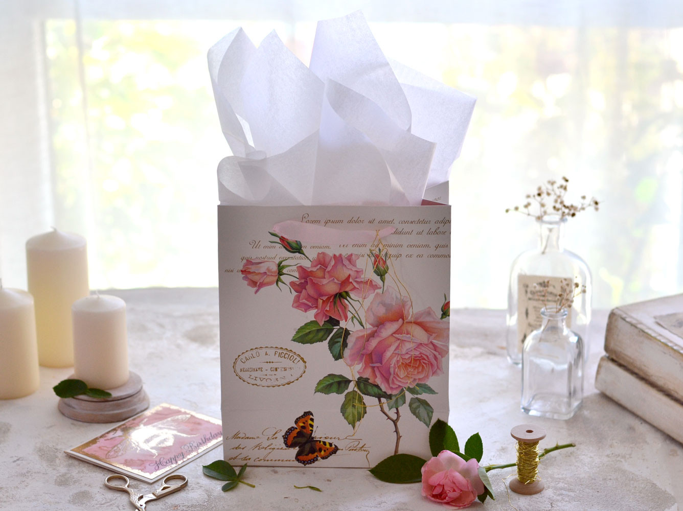 A rose themed gift bag with white tissue paper, demonstrating classic color pairing for gift wrapping.