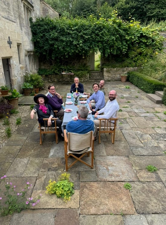 Friends enjoying lunch in the Cotswolds, a convivial gathering with thoughtful guests and delightful company
