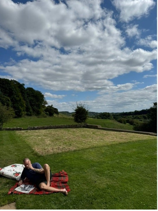 Chris Black relaxing on the lawn, enjoying the English countryside and the hospitality of his host