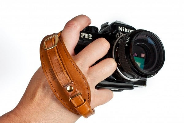 Leather camera hand strap, showcasing its craftsmanship and practical design for securely holding a camera, emphasizing comfort and style.