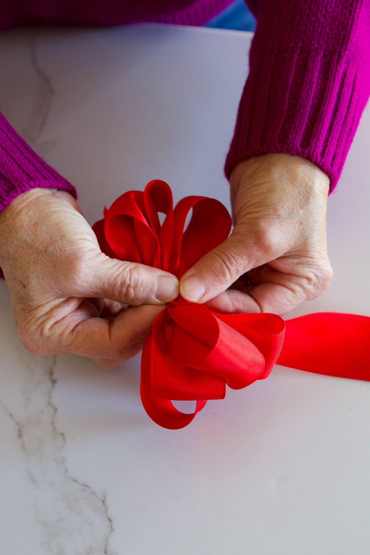 Step 7: Adding multiple loops on each side to create a full and poufy bow