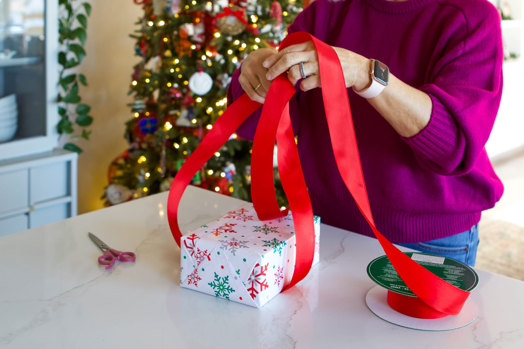 Step 2: Criss-crossing and knotting the ribbon to create the base wrap