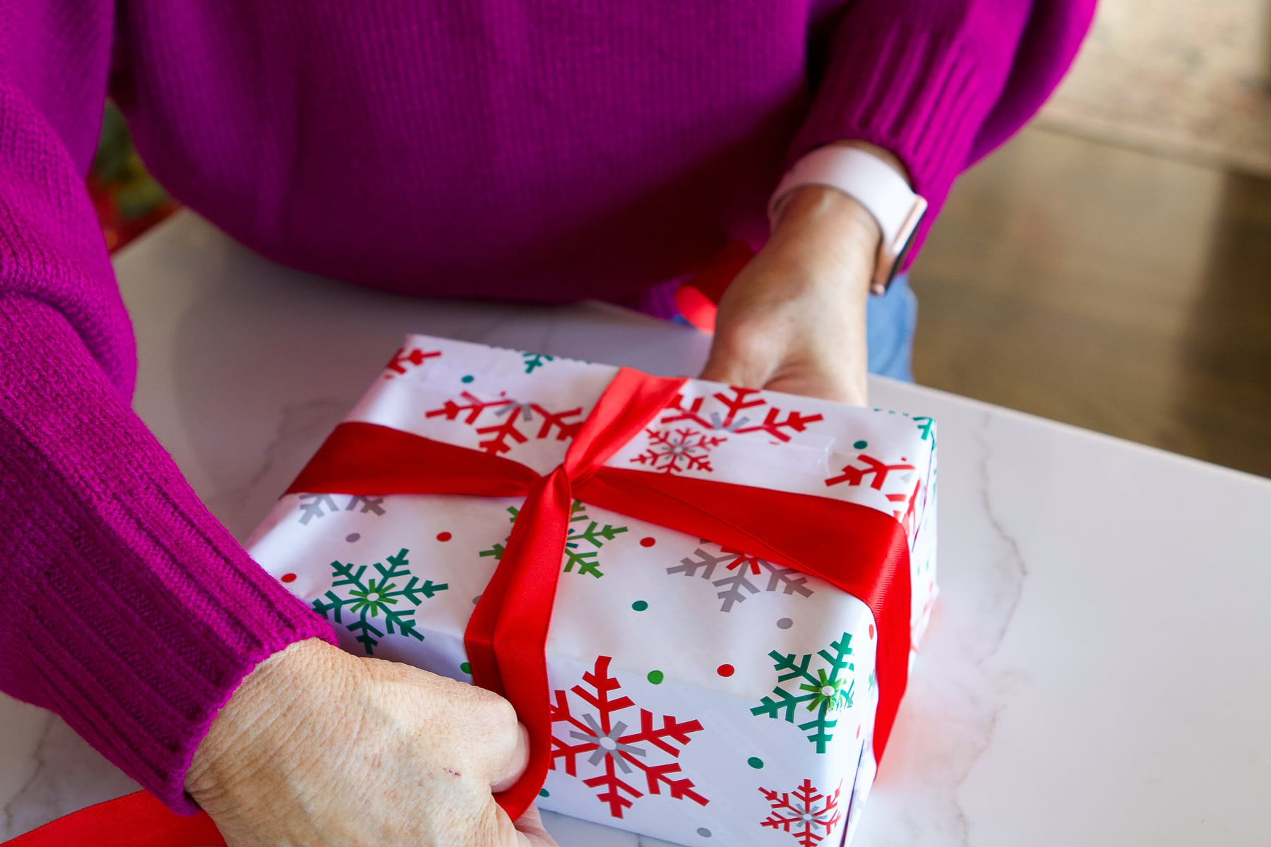 Step 4: Flipping the package to tie the initial knot for the bow base