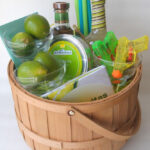 Close-up of a beautifully arranged DIY margarita gift set featuring glasses, ingredients, and a recipe book.