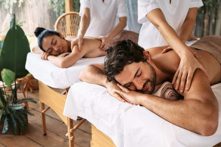 Couples massage, a relaxing birthday gift idea for wife, promoting relaxation and shared pampering (via Canva)