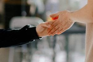 Hands gently touching in a supportive manner