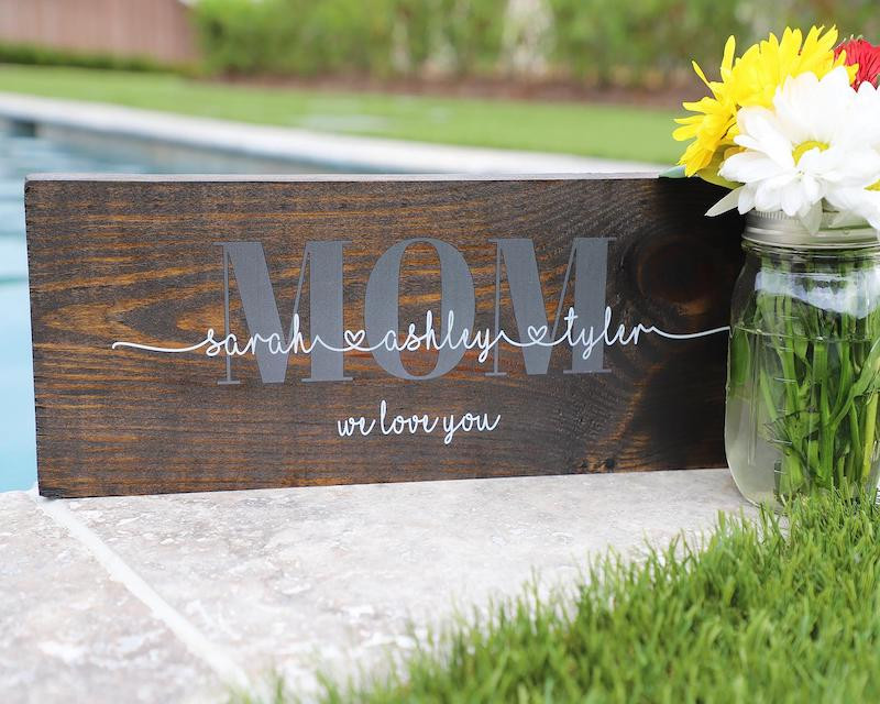 A personalized wooden sign for the mother of the bride, a heartwarming home décor gift.