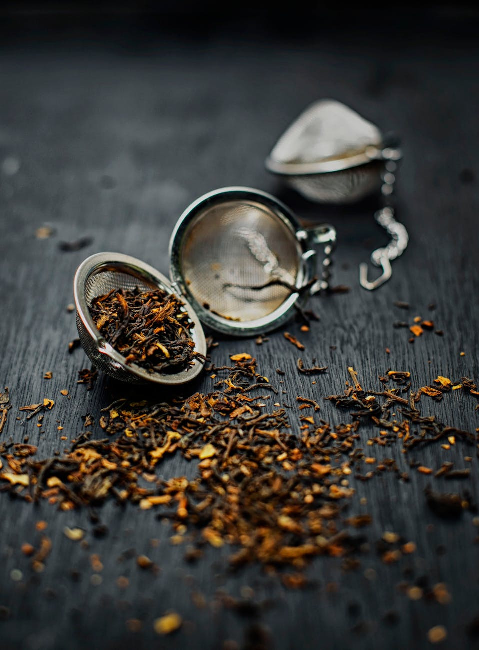 silver round tea strainer with tea leaves