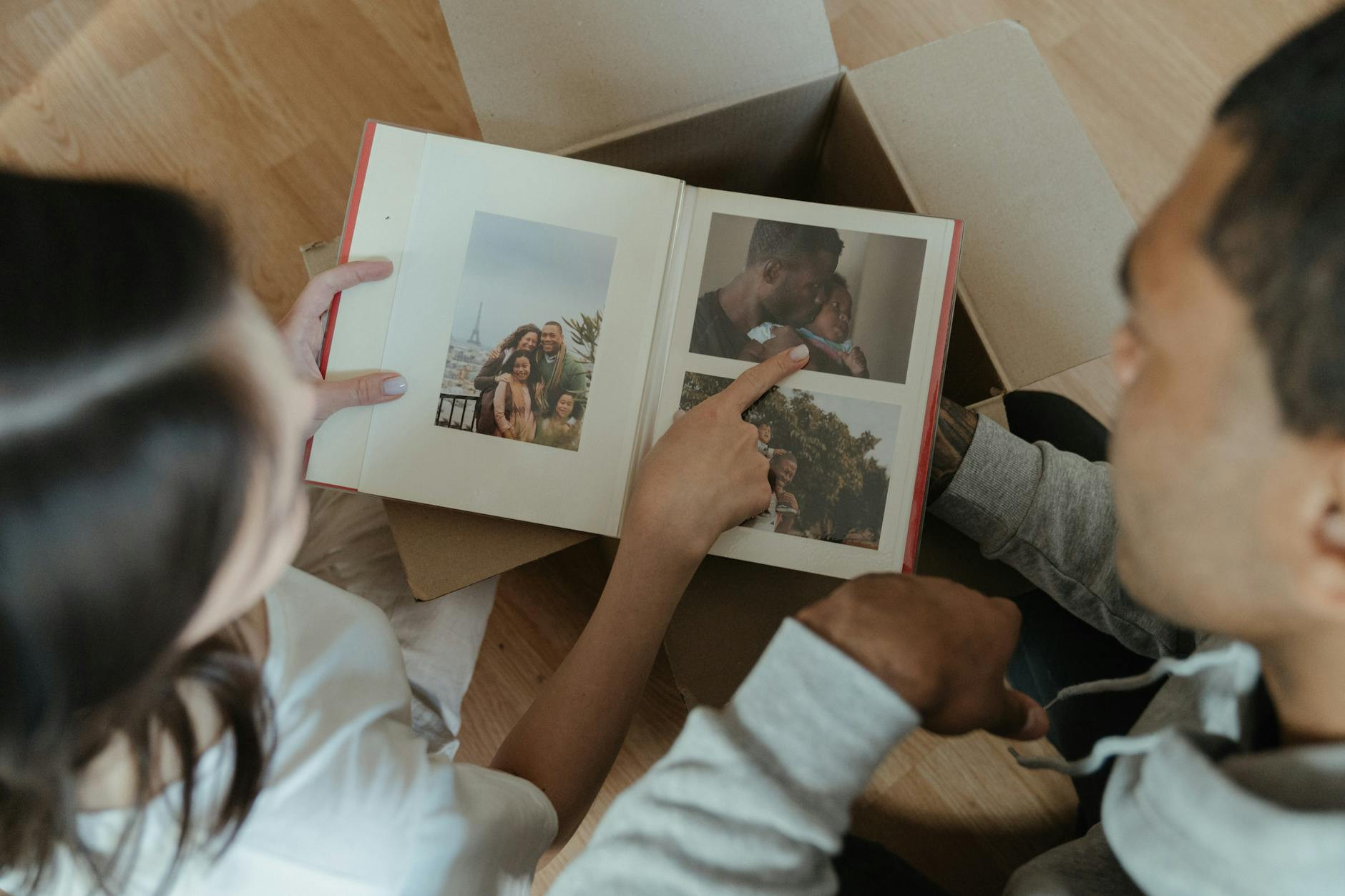 A man and woman looking at a photo album
