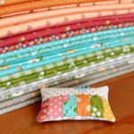 Close-up of a scrappy pincushion, a perfect sewing gift for any crafter