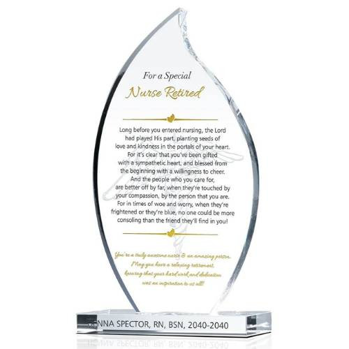 A flame-shaped glass plaque engraved with a retirement message for a nurse, resting on a wooden base.