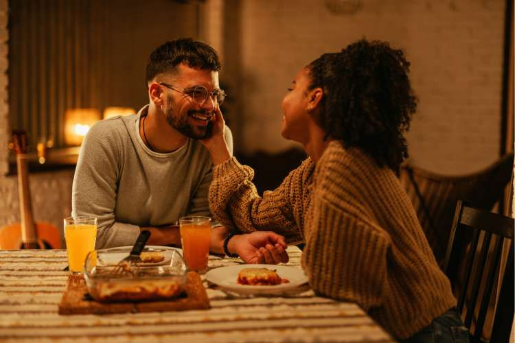 Romantic dinner at home, an intimate birthday gift idea for wife, creating a special and cozy atmosphere (via Canva)