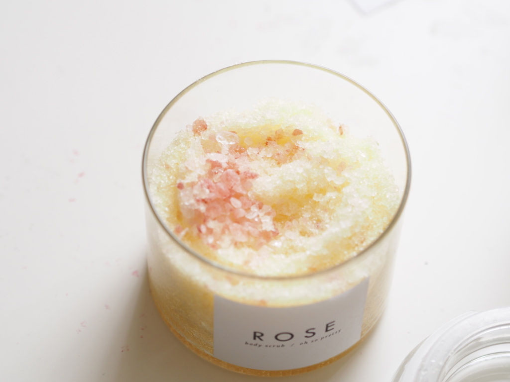 Close up of rose sugar scrub in a glass jar, showcasing its texture and rose petals, ideal for a homemade teacher gift.