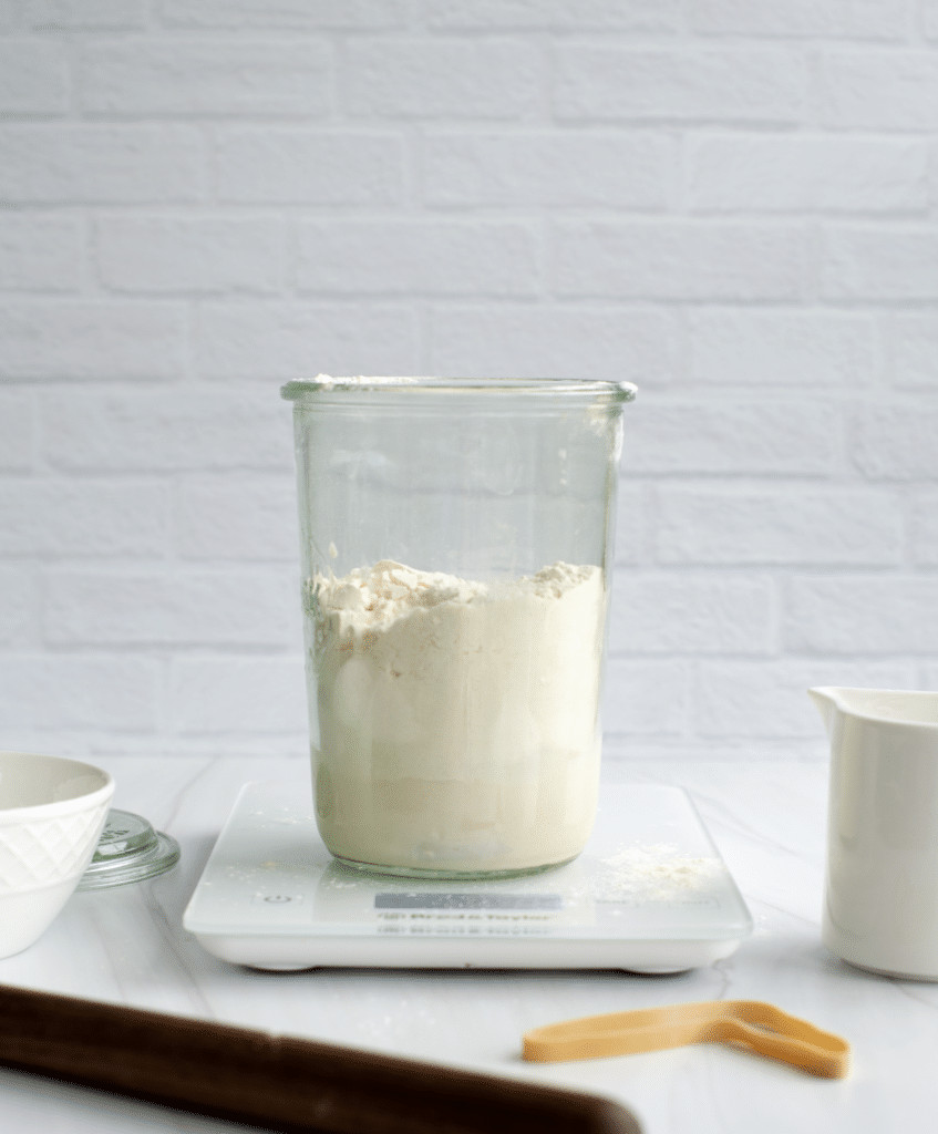 A digital kitchen scale with a stainless steel platform displaying a weight measurement, highlighting its importance for accurate sourdough baking.
