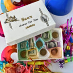 Open candy box revealing dollar bills and coins, creative money gift idea