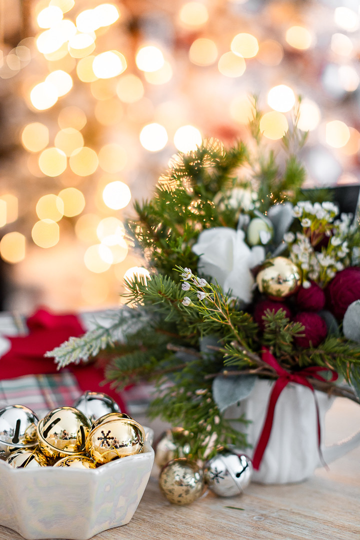Small Christmas flower arrangement featuring foraged greenery, a faux rose, and yarn balls, perfect for a gift card, showcasing a handmade Christmas gift idea