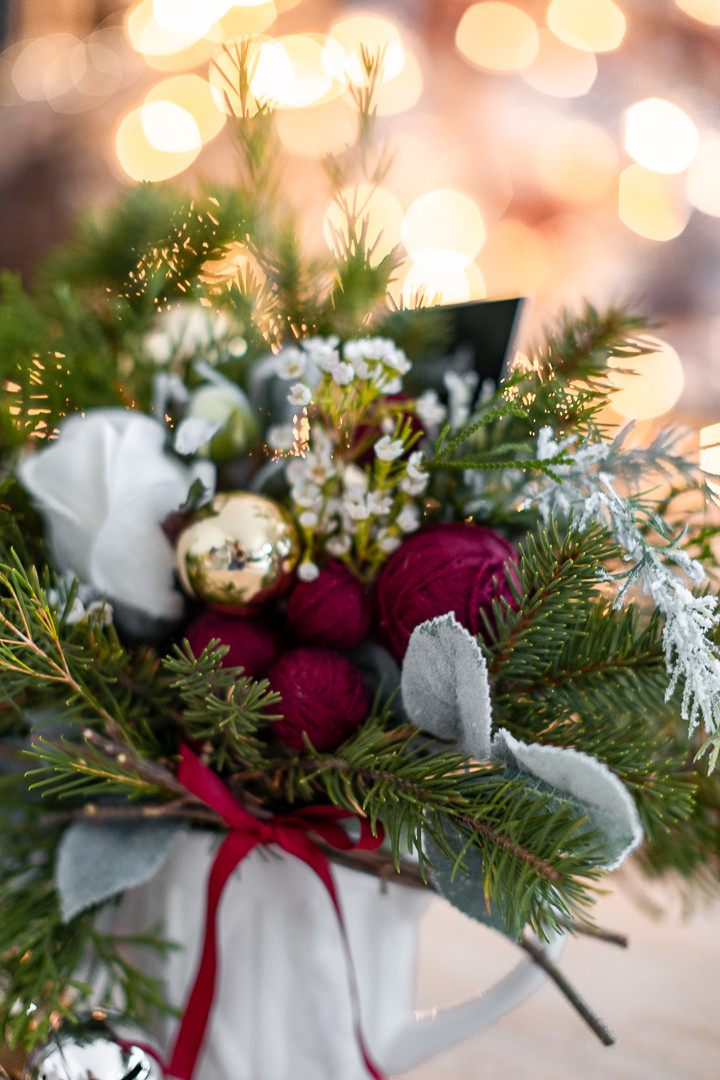 Close-up of a small Christmas bouquet with foraged greens and a faux rose, highlighting the details of this DIY small Christmas gift